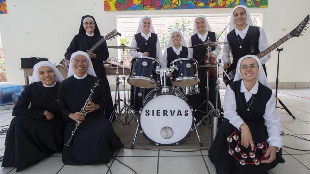 “This is another form of bringing our evangelical message, showing our strength -- that’s to say, it’s also music that we like, it shows a lot about who we are.” The band plays catchy Christian songs, indistinguishable from many of their peers in mainstream rock. But the appearance is very different, rock’s grunge and glad rags giving way to the nuns’ black and white habits and veils on stage. (Cris Bouroncle / AFP) “This is another form of bringing our evangelical message, showing our strength -- that’s to say, it’s also music that we like, it shows a lot about who we are.” The band plays catchy Christian songs, indistinguishable from many of their peers in mainstream rock. But the appearance is very different, rock’s grunge and glad rags giving way to the nuns’ black and white habits and veils on stage. (Cris Bouroncle / AFP)