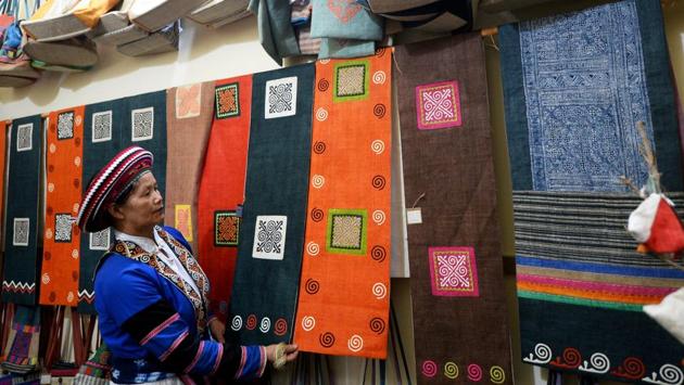 The lucky few who escape from China often face stigma upon their return and are shunned by neighbours. Driven to offer such victims a purpose -- and an income -- Vang Thi Mai set up the Lung Tam Linen Cooperative in 2001. “Society may not like them but here they are confident,” said Mai, dressed in a traditional pleated indigo hemp skirt and embroidered coat. (Nhac Nguyen / AFP) The lucky few who escape from China often face stigma upon their return and are shunned by neighbours. Driven to offer such victims a purpose -- and an income -- Vang Thi Mai set up the Lung Tam Linen Cooperative in 2001. “Society may not like them but here they are confident,” said Mai, dressed in a traditional pleated indigo hemp skirt and embroidered coat. (Nhac Nguyen / AFP)
