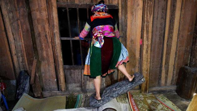 A Hmong woman softens textiles. The co-op quickly grew and today is a hive of activity that employs more than 130 women, not just trafficking victims but also orphans, single mothers and seniors, who weave, dye and stitch indigo blue and yam orange fabrics from dawn to dusk. (Nhac Nguyen / AFP) A Hmong woman softens textiles. The co-op quickly grew and today is a hive of activity that employs more than 130 women, not just trafficking victims but also orphans, single mothers and seniors, who weave, dye and stitch indigo blue and yam orange fabrics from dawn to dusk. (Nhac Nguyen / AFP)