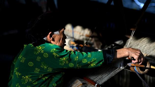 An eighty-year-old Hmong woman weaves textile. “If women, especially trafficked women, are working in a group together they make themselves stronger by gaining negotiating power, accelerating knowledge and integrating into society,” said Nguyen Tien Phong, head of inclusive growth at United Nations Development Programme in Vietnam. (Nhac Nguyen / AFP) An eighty-year-old Hmong woman weaves textile. “If women, especially trafficked women, are working in a group together they make themselves stronger by gaining negotiating power, accelerating knowledge and integrating into society,” said Nguyen Tien Phong, head of inclusive growth at United Nations Development Programme in Vietnam. (Nhac Nguyen / AFP)