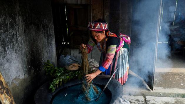 A girl dyes textiles at the Lung Tam Linen cooperative. The collective makes hemp handbags and table runners, coasters and stuffed animals, and the women can earn up to $170 per month, a decent wage in impoverished Ha Giang province. (Nhac Nguyen / AFP) A girl dyes textiles at the Lung Tam Linen cooperative. The collective makes hemp handbags and table runners, coasters and stuffed animals, and the women can earn up to $170 per month, a decent wage in impoverished Ha Giang province. (Nhac Nguyen / AFP)