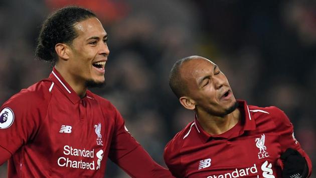 File image of Liverpool's Brazilian midfielder Fabinho (R) celebrates with Liverpool's Dutch defender Virgil van Dijk (L).(AFP)