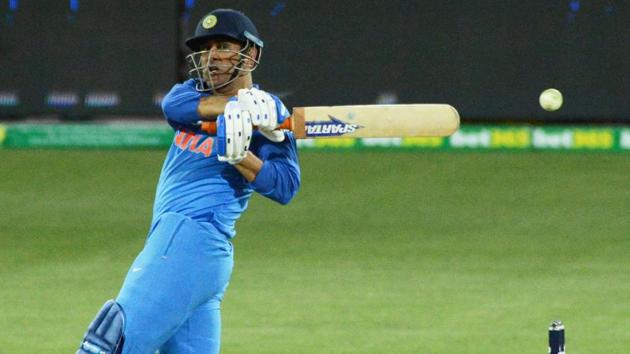 MS Dhoni hits the ball during the third ODI match against Australia.(AFP)