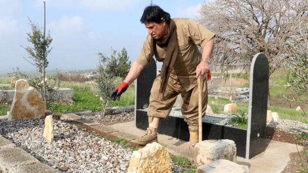 Hoshyar Ali points to the tomb where both his legs are buried in the Kurdish town of Halabja, Iraq. (Ako Rasheed / REUTERS) Hoshyar Ali points to the tomb where both his legs are buried in the Kurdish town of Halabja, Iraq. (Ako Rasheed / REUTERS)
