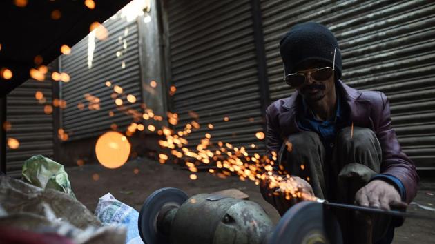 A Pakistani craftsman sharps a knife at an iron workshop in Karachi. (Asif Hassan / AFP) A Pakistani craftsman sharps a knife at an iron workshop in Karachi. (Asif Hassan / AFP)
