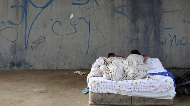 A Venezuelan couple sleeps near a bus terminal in Manaus, Brazil. (Bruno Kelly / REUTERS) A Venezuelan couple sleeps near a bus terminal in Manaus, Brazil. (Bruno Kelly / REUTERS)
