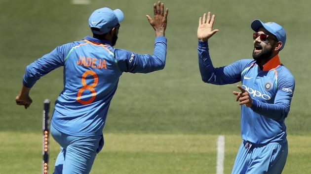 Ravindra Jadeja, left, and Virat Kohli celebrate the wicket of Australia's Usman Khawaja.(AP)