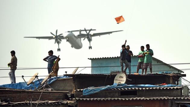 Children fly kites from rooftops on Makar Sankranti while an aircraft passes by in Mumbai, Maharashtra. (Vijayanand Gupta / HT Photo) Children fly kites from rooftops on Makar Sankranti while an aircraft passes by in Mumbai, Maharashtra. (Vijayanand Gupta / HT Photo)
