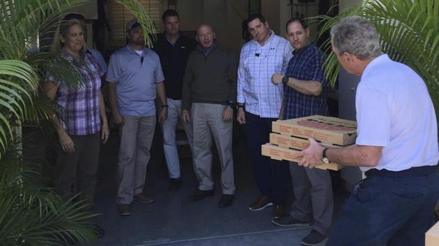 In this undated image posted on former President George W. Bush's Instagram account on Friday, Jan. 19, 2019, Bush, right, delivers pizzas to his secret service detail in Florida.(AP Photo) In this undated image posted on former President George W. Bush's Instagram account on Friday, Jan. 19, 2019, Bush, right, delivers pizzas to his secret service detail in Florida.(AP Photo)