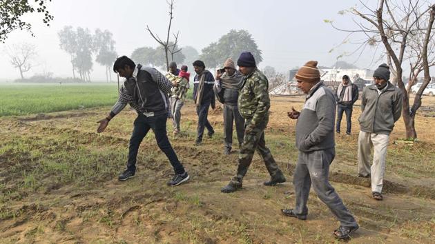 Villages and officials of the wildlife department search for the leopard’s pug marks in the fields of Patli, after the big cat was captured roaming the fields in the night on CCTV cameras. (Sanchit Khanna / HT Photo) Villages and officials of the wildlife department search for the leopard’s pug marks in the fields of Patli, after the big cat was captured roaming the fields in the night on CCTV cameras. (Sanchit Khanna / HT Photo)