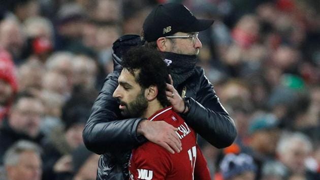 Liverpool's Mohamed Salah is embraced by manager Juergen Klopp.(REUTERS)