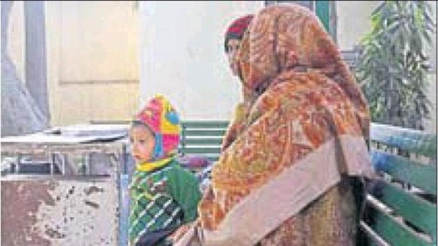 The woman’s family members wait to receive the body inside the mortuary on Friday.(HT Photo) The woman’s family members wait to receive the body inside the mortuary on Friday.(HT Photo)