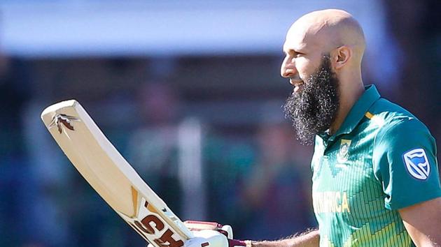 South African batsman Hashim Amla raises his bat as he celebrates scoring a century (100 runs) during the first One Day International (ODI) match between South Africa and Pakistan at St. George's cricket stadium.(AFP)