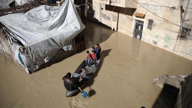 Children enjoy a ride on a small boat along a flooded street. The ground floors of houses close to the river have been inundated. The mainly Sunni Arab town close the Turkish border lies in Idlib province which is largely under the control of jihadists led by Al-Qaeda’s former Syria branch. (Aaref Watad / AFP)