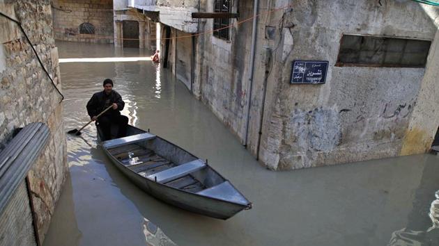 The alleyways of the Syrian town of Darkush in Syria are normally thronged with pedestrians but since the swollen Orontes River burst its banks, Abu Ihab’s boat has provided the main way of getting around. The 49-year-old farmer normally takes a well-earned rest in January when winter frosts turn his fields as hard as rock. (Aaref Watad / AFP)