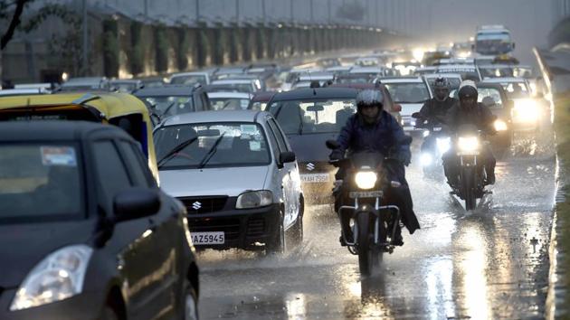 New Delhi: Traffic move on a street during rains as dark clouds hover over New Delhi, Tuesday morning, Jan 22, 2019. (PTI) New Delhi: Traffic move on a street during rains as dark clouds hover over New Delhi, Tuesday morning, Jan 22, 2019. (PTI)