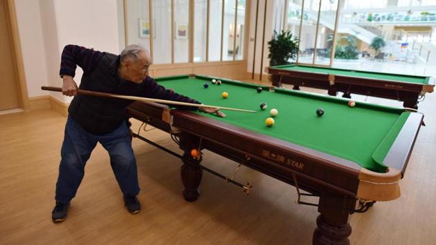 A resident plays pool in a recreation area at the Yanyuan community. The push to grow China’s elderly care capacity has encouraged more private companies, from real estate developers to insurance firms, to seize on business opportunities in the industry, such as nursing homes where residents enjoy five-star accommodations and professional medical support. (Greg Baker / AFP) A resident plays pool in a recreation area at the Yanyuan community. The push to grow China’s elderly care capacity has encouraged more private companies, from real estate developers to insurance firms, to seize on business opportunities in the industry, such as nursing homes where residents enjoy five-star accommodations and professional medical support. (Greg Baker / AFP)