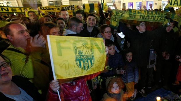 Fans gather near a row of yellow tulips in Nantes' city center after news that newly-signed Cardiff City soccer player Emiliano Sala was missing after the light aircraft he was travelling in disappeared between France and England the previous evening.(REUTERS)