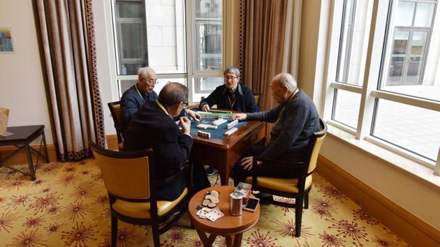 Residents play mahjong in a recreation area at the Yanyuan community for senior citizens, on the outskirts of Beijing. A grand piano backlit by floor-to-ceiling windows stands in the community’s clubhouse living room. Brightly coloured artworks commissioned from Israeli artist David Gerstein adorn public spaces. (Greg Baker / AFP) Residents play mahjong in a recreation area at the Yanyuan community for senior citizens, on the outskirts of Beijing. A grand piano backlit by floor-to-ceiling windows stands in the community’s clubhouse living room. Brightly coloured artworks commissioned from Israeli artist David Gerstein adorn public spaces. (Greg Baker / AFP)