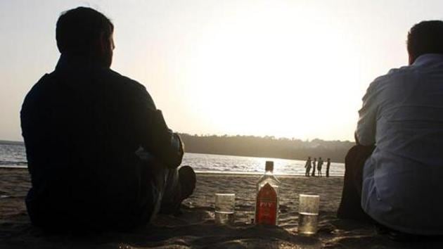 Tourists enjoying local beverage Feni at Bambolim beach, in Goa on May 25, 2012. (HT File Photo) Tourists enjoying local beverage Feni at Bambolim beach, in Goa on May 25, 2012. (HT File Photo)