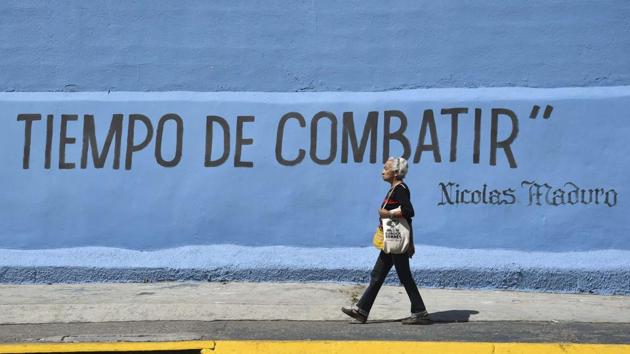 A woman passes by graffiti reading “Time to Fight”. The uprising was quickly put down and twenty-seven soldiers arrested. The brief rebellion triggered demonstrations in a number of neighbourhoods in Caracas. The same day the Supreme Court, dominated by regime loyalists, declared the opposition-controlled National Assembly leadership illegitimate and its decisions invalid. (Yuri Cortez / AFP) A woman passes by graffiti reading “Time to Fight”. The uprising was quickly put down and twenty-seven soldiers arrested. The brief rebellion triggered demonstrations in a number of neighbourhoods in Caracas. The same day the Supreme Court, dominated by regime loyalists, declared the opposition-controlled National Assembly leadership illegitimate and its decisions invalid. (Yuri Cortez / AFP)