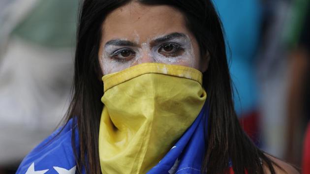 An anti-government protester after a rally demanding the resignation of President Nicolas Maduro in Caracas. Flanked by military top brass, Defense Minister Vladimir Padrino, himself a general, declared the 56-year-old Maduro “the legitimate president” on Thursday -- and vowed to defend his authority against an attempted “coup d’etat”. (Fernando Llano / AP) An anti-government protester after a rally demanding the resignation of President Nicolas Maduro in Caracas. Flanked by military top brass, Defense Minister Vladimir Padrino, himself a general, declared the 56-year-old Maduro “the legitimate president” on Thursday -- and vowed to defend his authority against an attempted “coup d’etat”. (Fernando Llano / AP)