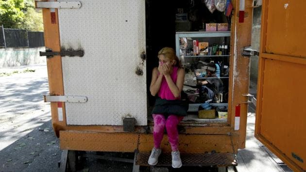 A resident of the San Jose del Avila’s neighborhood covers her nose from the lingering odour of tear gas. Russian President Vladimir Putin called Maduro to express support, charging that the “crisis has been provoked from the outside”. China, Venezuela’s main creditor, opposed “interference in Venezuelan affairs by external forces”. (Fernando Llano / AP) A resident of the San Jose del Avila’s neighborhood covers her nose from the lingering odour of tear gas. Russian President Vladimir Putin called Maduro to express support, charging that the “crisis has been provoked from the outside”. China, Venezuela’s main creditor, opposed “interference in Venezuelan affairs by external forces”. (Fernando Llano / AP)