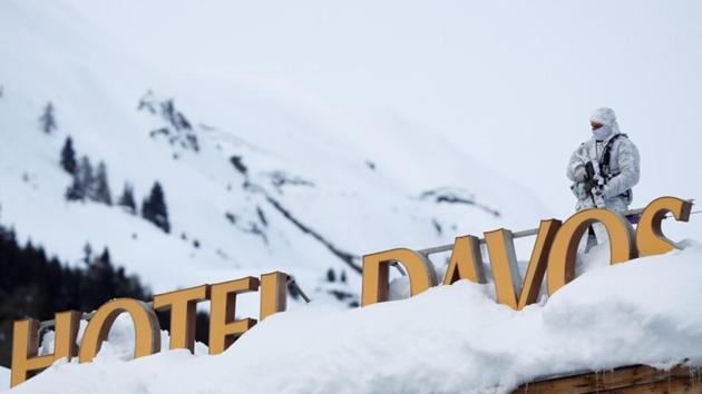 A Swiss police officer observes the surrounding area from atop the roof of the Davos Congress Hotel ahead of the World Economic Forum (WEF) annual meeting in Davos, Switzerland. (Arnd Wiegmann / REUTERS) A Swiss police officer observes the surrounding area from atop the roof of the Davos Congress Hotel ahead of the World Economic Forum (WEF) annual meeting in Davos, Switzerland. (Arnd Wiegmann / REUTERS)