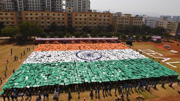 Students of Zeal institute create a formation of India's national flag on the eve of 70th Republic Day of India in the college on Friday. The formation was made with the help of 3,563 painted card boards each with a size 2.5 x 2.5 feet. (Pratham Gokhale/HT Photo) 