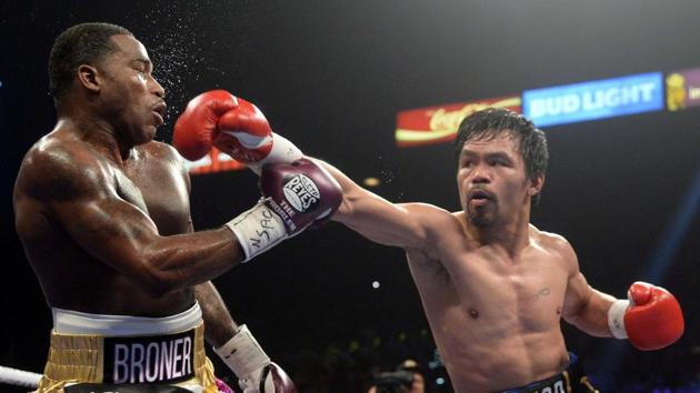 Manny Pacquiao (black trunks) and Adrien Broner (purple/gold trunks) box during a WBA welterweight world title boxing match at MGM Grand Garden Arena in Las Vegas, Nevada. Pacquiao won via unanimous decision. (Joe Camporeale / USA TODAY Sports / REUTERS) Manny Pacquiao (black trunks) and Adrien Broner (purple/gold trunks) box during a WBA welterweight world title boxing match at MGM Grand Garden Arena in Las Vegas, Nevada. Pacquiao won via unanimous decision. (Joe Camporeale / USA TODAY Sports / REUTERS)