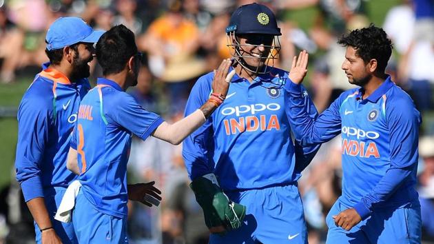 India's Kuldeep Yadav (R), Yuzvendra Chahal (front L) and wicketkeeper Mahendra Singh Dhoni (C) celebrate.(AFP)