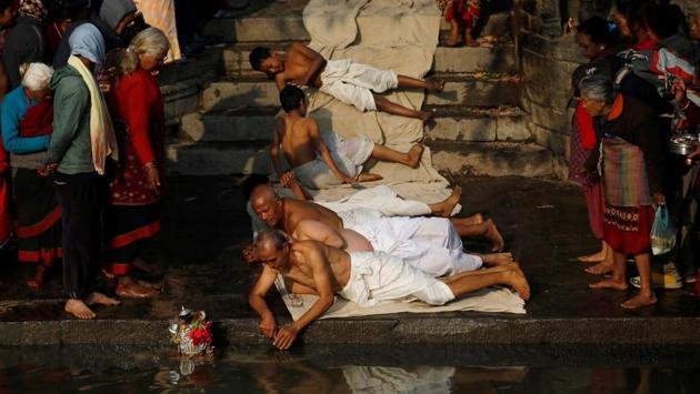Devotees offer prayers by rolling on the ground during the Swasthani Brata Katha festival in Bhaktapur, Nepal. (Navesh Chitrakar / REUTERS) Devotees offer prayers by rolling on the ground during the Swasthani Brata Katha festival in Bhaktapur, Nepal. (Navesh Chitrakar / REUTERS)
