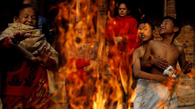 Devotees gather near a fire to keep warm as they prepare to take part for the Swasthani Brata Katha festival in Bhaktapur, Nepal. (Navesh Chitrakar / REUTERS) Devotees gather near a fire to keep warm as they prepare to take part for the Swasthani Brata Katha festival in Bhaktapur, Nepal. (Navesh Chitrakar / REUTERS)