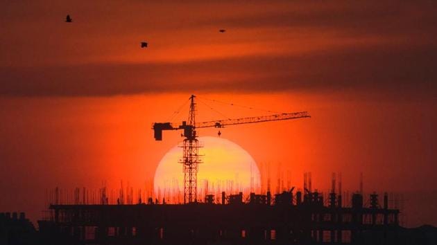 Labourers work at building construction site during a sunset in Yangon, Myanmar. (Ye Aung Thu / AFP) Labourers work at building construction site during a sunset in Yangon, Myanmar. (Ye Aung Thu / AFP)