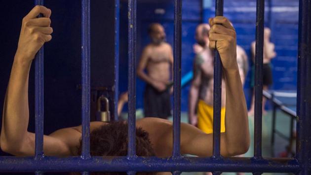 Foreign detainees are pictured behind bars at an immigration detention centre in Bangkok, during a visit organized by authorities for journalists. (Romeo Gacad / AFP) Foreign detainees are pictured behind bars at an immigration detention centre in Bangkok, during a visit organized by authorities for journalists. (Romeo Gacad / AFP)