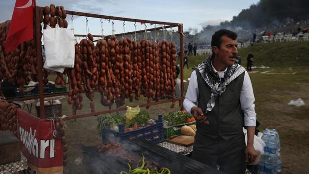 A vendor offers sausages for sale to spectators during Turkey’s largest camel wrestling festival. The Selcuk festival, one of the most important, is held every year on the third weekend of January. (Lefteris Pitarakis / AP) A vendor offers sausages for sale to spectators during Turkey’s largest camel wrestling festival. The Selcuk festival, one of the most important, is held every year on the third weekend of January. (Lefteris Pitarakis / AP)