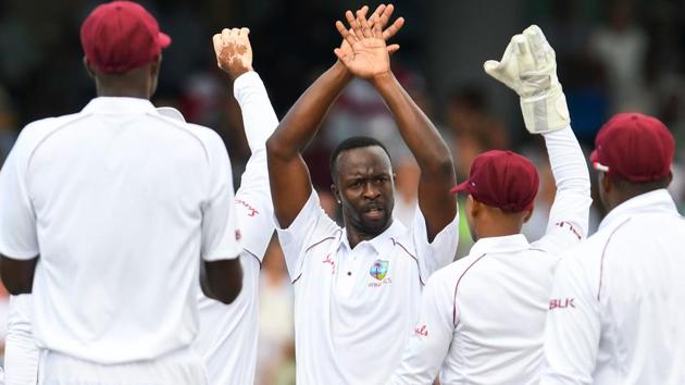 Kemar Roach (C) of West Indies celebrates the dismissal of Ben Stokes of England.(AFP)