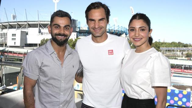 Indian cricket captain Virat Kohli, left, and his wife Anushka Sharma pose for a photo with Switzerland's Roger Federer at the Australian Open.(AP)
