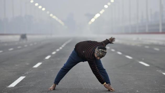 A worker exercises on a newly constructed bridge, prior to its inauguration at Kalindi Kunj, on a cold morning, in New Delhi. (Burhaan Kinu / HT Photo) A worker exercises on a newly constructed bridge, prior to its inauguration at Kalindi Kunj, on a cold morning, in New Delhi. (Burhaan Kinu / HT Photo)