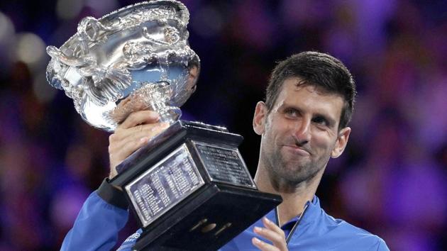 Novak Djokovic holds his trophy aloft after defeating Spain's Rafael Nadal.(AP)