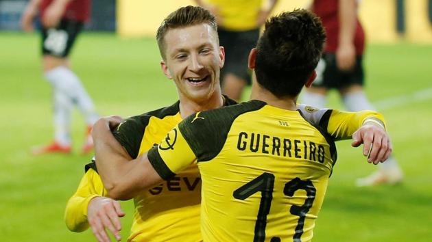 Borussia Dortmund's Raphael Guerreiro celebrates scoring their fourth goal with Marco Reus.(REUTERS)