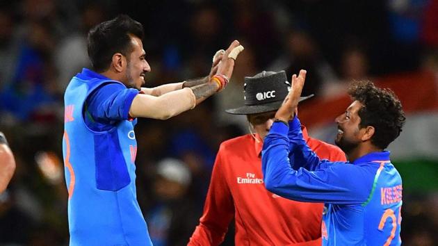 New Zealand's Colin de Grandhomme (L) walks from the field after being caught as India's Yuzvendra Chahal (C and India's Kuldeep Yadav celebrate during the second one-day international (ODI).(AFP)