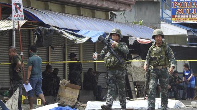 Soldiers attend the scene after two bombs exploded outside a Roman Catholic cathedral in Jolo, the capital of Sulu province in southern Philippines, Sunday, Jan. 27, 2019. Two bombs minutes apart tore through a Roman Catholic cathedral on a southern Philippine island where Muslim militants are active, killing at least 20 people and wounding more than 80 others during a Sunday Mass, officials said. (AP Photo/Nickee Butlangan)(AP)