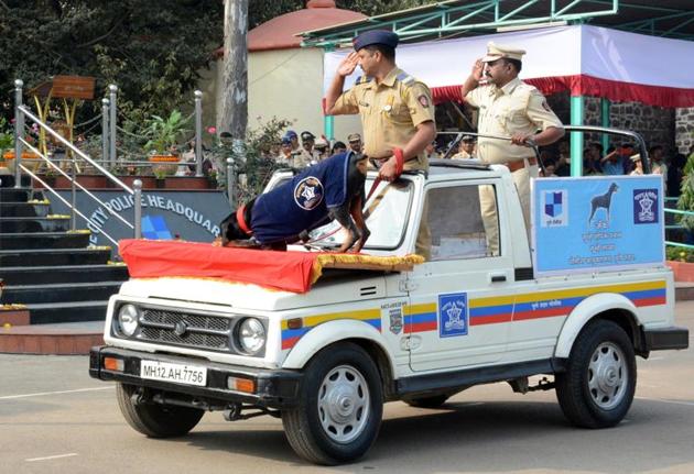 Police personnel along with a member of Pune police dog squad salute the flag during the Republic Day parade at Shivajinagar Police ground (HT PHOTO) 