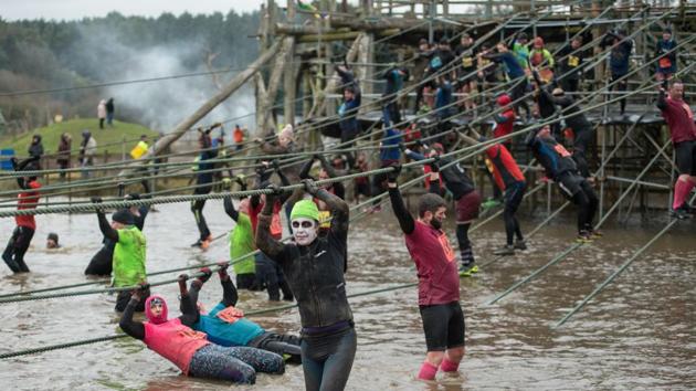 This year the event had obstacles designed to test the limits of endurance, from the “Colditz Walls” and “Tyre Torture” to “Vietcong Tunnels”. (Oli Scarff / AFP) This year the event had obstacles designed to test the limits of endurance, from the “Colditz Walls” and “Tyre Torture” to “Vietcong Tunnels”. (Oli Scarff / AFP)