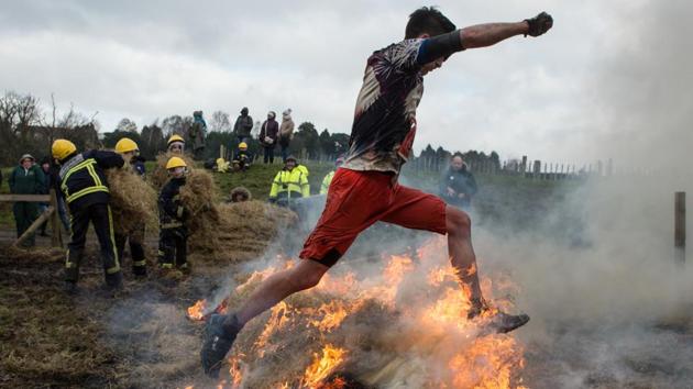A competitor makes their way through fire while emergency personnel standby. “This morning I wanted to find a way out of doing it. And then you get to the end and you think ‘actually, I have done this’. It makes you proud of yourself and what you have achieved.” (Oli Scarff / AFP) A competitor makes their way through fire while emergency personnel standby. “This morning I wanted to find a way out of doing it. And then you get to the end and you think ‘actually, I have done this’. It makes you proud of yourself and what you have achieved.” (Oli Scarff / AFP)