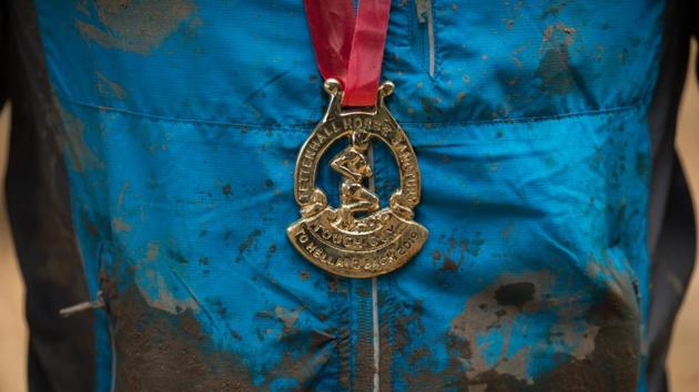 A competitor wears his finisher's medal. Previously there have been thousands of competitors, but the numbers this time were limited to ensure everybody could finish before it got dark Mouse said. Many will return again and again. “It’s like a pilgrimage.” (Oli Scarff / AFP) A competitor wears his finisher's medal. Previously there have been thousands of competitors, but the numbers this time were limited to ensure everybody could finish before it got dark Mouse said. Many will return again and again. “It’s like a pilgrimage.” (Oli Scarff / AFP)