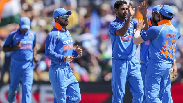 Bhuvneshwar Kumar, third right, is congratulated by Virat Kohli on the wicket of Martin Guptil. (AP)