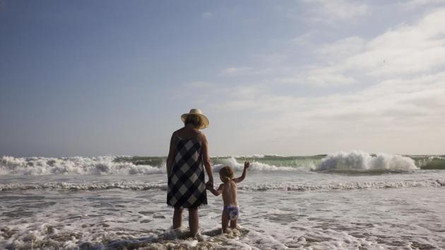 Mollie Biggers holds the hand of her deceased son's 2-year-old daughter, while spending time together at Huntington Beach. The last time she saw her son, he was lying in the coroner’s office and she tousled his hair. He’d let her cut it until he was in high school, and she’d loved it. He’d felt in those moments like her little boy. (Jae C. Hong / AP) Mollie Biggers holds the hand of her deceased son's 2-year-old daughter, while spending time together at Huntington Beach. The last time she saw her son, he was lying in the coroner’s office and she tousled his hair. He’d let her cut it until he was in high school, and she’d loved it. He’d felt in those moments like her little boy. (Jae C. Hong / AP)