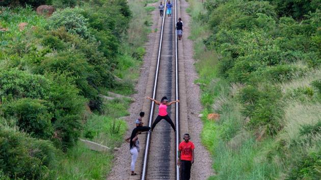 Some also jog along the railway, from one concrete sleeper to the next. “That’s not the best exercise -- it could lead to injury,” warned amateur football coach Julius Ndlovu, who brought two young players from a local side for pre-season training before matches start in March. “Many kids take drugs but if they come here in the morning they avoid that,” he said. (Zinyange Auntony / AFP) Some also jog along the railway, from one concrete sleeper to the next. “That’s not the best exercise -- it could lead to injury,” warned amateur football coach Julius Ndlovu, who brought two young players from a local side for pre-season training before matches start in March. “Many kids take drugs but if they come here in the morning they avoid that,” he said. (Zinyange Auntony / AFP)